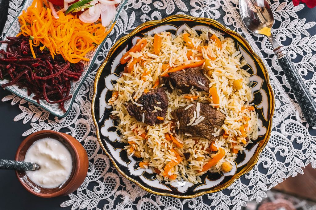 top-view-of-rice-with-carrot-cooked-with-lamb-served-with-yogurt-and-salad.jpg